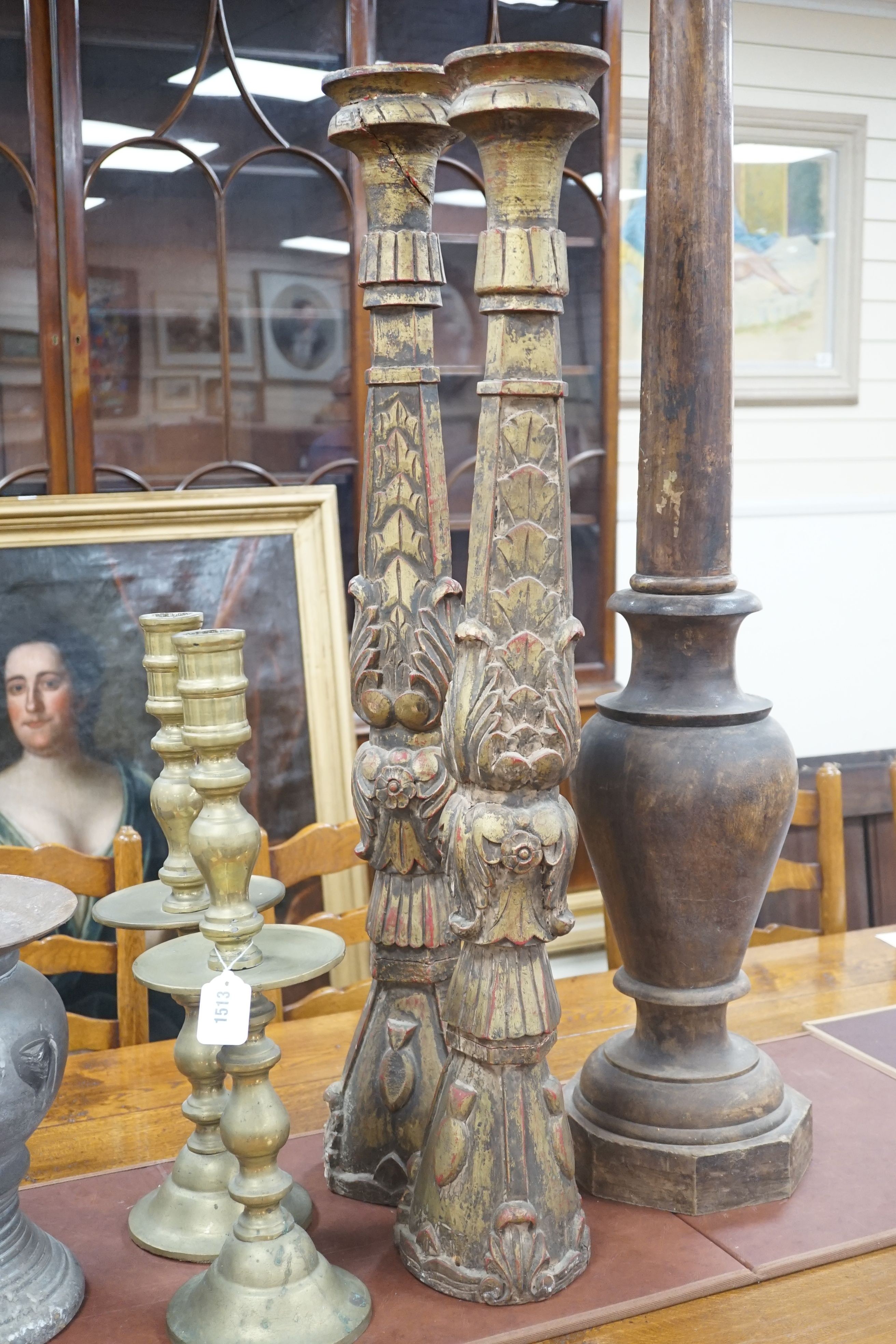 A pair of gilt carved candlesticks, a large turned candlestick, a pair of brass candlesticks and a squat metal candle stick (6), tallest 140cms.